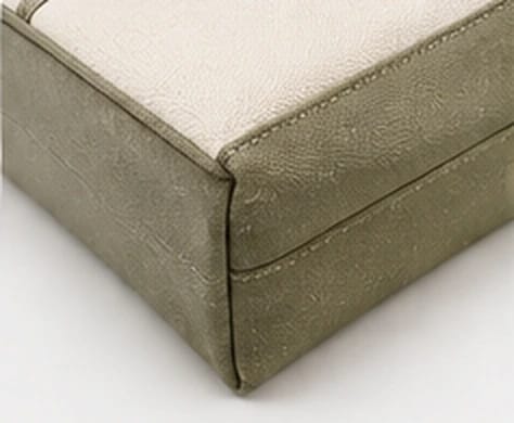 Close-up of the reinforced contrast base corner of the tote
